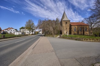 Protestant church Volmerdingsen, wall, bare winter trees, lawn, modern apartment building, general
