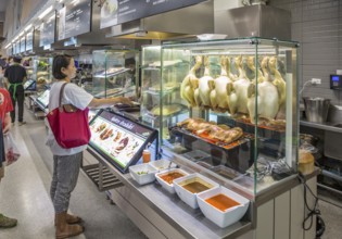 Thai woman ordering food in the cafeteria at the Big C Supercenter in Chiang Rai, Thailand, Asia