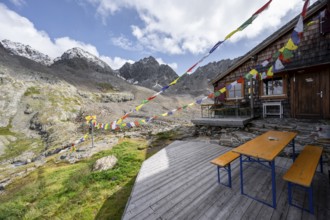 Colourful prayer flags, terrace at a mountain hut, mountain hut Adolf-Nossberger-Hütte, mountain