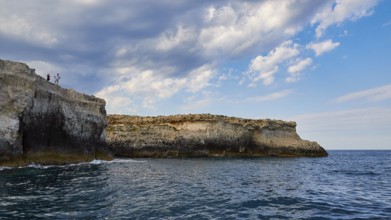 Rocky coast with cloudy sky and blue sea, boat trip around the island of Ortigia, Isola di Ortigia,
