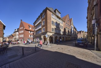 City centre, pedestrian zone, general architecture, brick buildings, parking lane with vehicles,