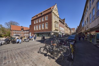 Old town, historic buildings, gables, bicycles, cobblestone street, outdoor area of a restaurant,