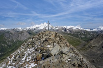 Böses Weibl summit with summit cross and colourful prayer flags, view of picturesque mountain