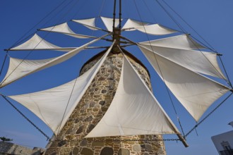 Sails of a stone windmill unfurl under a clear sky, Windmill, Antimacheia, Kos, Dodecanese, Greek