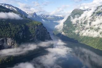View over the Geirangerfjord, Ørnesvingen viewpoint, atmospheric clouds over the fjord in the