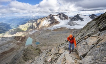 Mountaineer with helmet on a rope-insured path, in high mountain landscape, view of blue glacier
