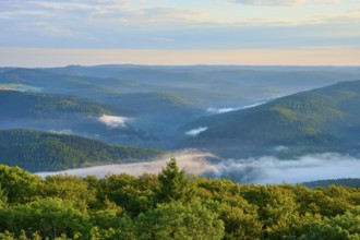 Green wooded hills, light mist in the valleys, calm blue sky, Katzenbuckel, Waldbrunn,