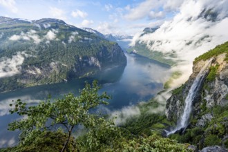 Gjerdefossen waterfall, at Ørnesvingen viewpoint, atmospheric clouds over the fjord in the morning