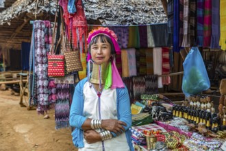 Tribal woman selling woven scarves and other crafts in the Long Neck Karen tribe (more properly