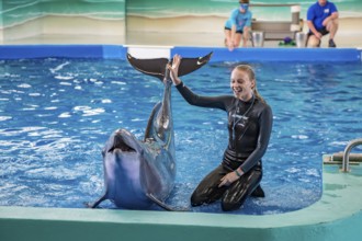 Trainers working with Dolphins during show at Ocean Adventures Marine Park in Gulfport, Mississippi