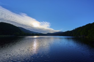 Lake at sunrise with soft light and wooded hills, summer, Rursee, Obersee, Rurberg, Simmerath,