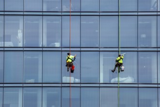 Detroit, Michigan - Window washers at the 25-story Residences Water Square luxury apartment
