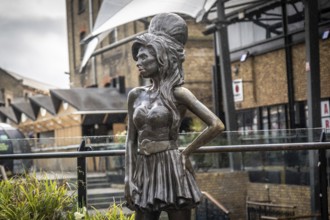 Bronze statue of the late singer amy winehouse, standing proudly in stables market, camden town,