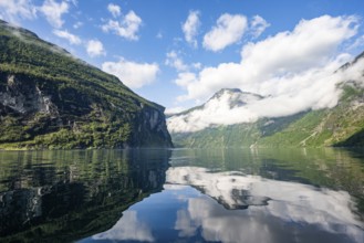 Atmospheric fjord landscape at Geirangerfjord with reflection, Møre og Romsdal, Norway, Europe