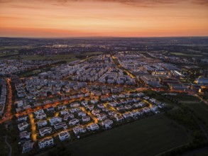 Dawn behind the Riedberg district of Frankfurt heralds the imminent sunrise. (Aerial view with a