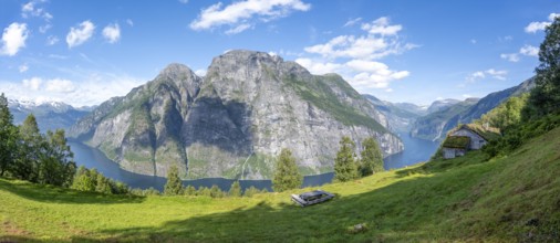 Panorama at Blomberg Gård, historic mountain farm with grass roof on a steep mountainside above the