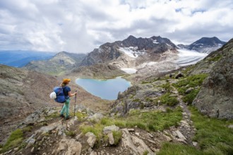 Mountaineer in rocky high mountain landscape, view of mountains with mountain lake Vogelhüttensee