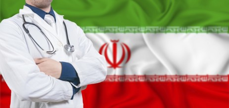 Iran healthcare concept. Male doctor on Iran flag. Doctor with crossed arms on Iran flag