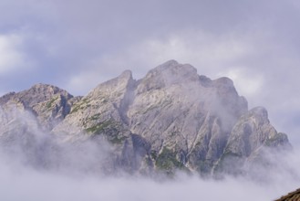 Dramatic mountain peaks shrouded in mystical fog, Dolomites, South Tyrol, Dolomites, Italy, Europe