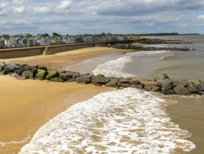 View north of sandy beach and coastal defences from pier, Southwold, Suffolk, England, UK