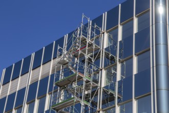 Steel scaffolding on the large glass façade of an office building