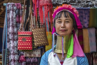 Tribal woman selling woven scarves and other crafts in the Long Neck Karen tribe (more properly