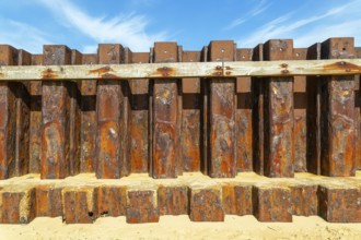 Old rusty steel sheet piling sea wall coastal defence, River Deben, Bawdsey, Suffolk, England, UK