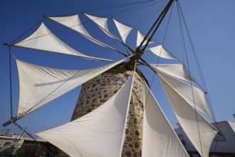 Close-up of sails on a stone windmill under a blue sky, Windmill, Antimacheia, Kos, Dodecanese,