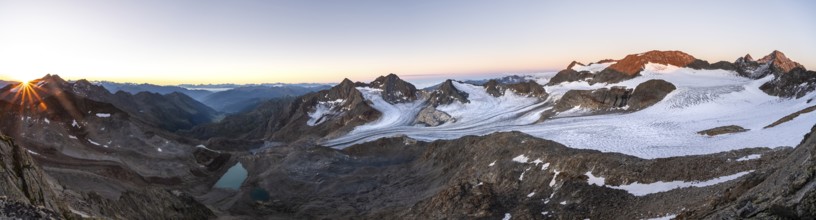 Panorama at sunrise with sun star, high mountain landscape, view of blue glacial lakes, mountain