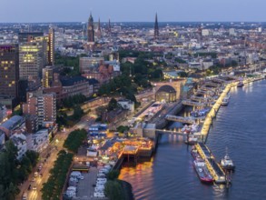 Aerial view of the jetties in the harbour at blue hour with churches in the background, Hamburg,