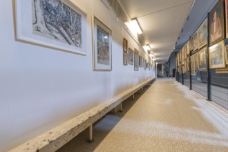 Long gallery corridor with paintings and a bench, historical art exhibition in the old swimming