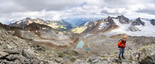 Mountain panorama, mountaineer with helmet on a rocky hiking trail, in high mountain landscape,