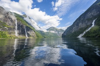 Atmospheric fjord landscape with waterfall The Seven Sisters and Freier Waterfall, Geirangerfjord