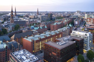 Aerial view of the Speicherstadt with striking brick buildings and high towers under an evening