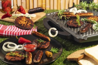 Burgers and sausages on plates, grill and floating surrounded by bread and herbs in a summery