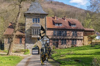 Knight on horseback in front of gatehouse to Schaumburg Germany Composing