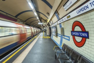 Motion blur of a london underground train arriving at camden town station with its distinctive