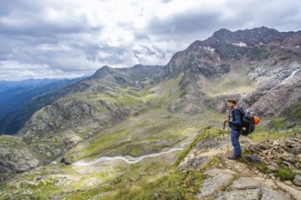 Mountaineer on a hiking trail, view of mountain landscape with Bodenbach, at the Treplitzerhütte,