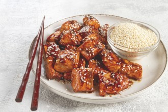 Fried pieces of salmon teriyaki with sesame seeds, top view