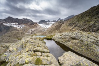 Rocky mountain landscape with dark clouds, high mountain landscape with glacier Übeltalferner,