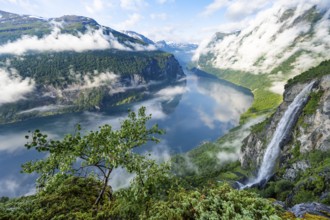 Gjerdefossen waterfall, at Ørnesvingen viewpoint, atmospheric clouds over the fjord in the morning