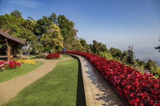 Colorful lush flower gardens line the perimeter of the mountain top Doi Tung Royal Villa lawn with