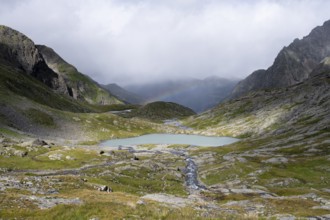 Turquoise-blue mountain lake Mittersee and rainbow, Schober group, Hohe Tauern National Park,
