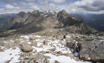 Mountaineer in rocky mountain landscape, descent from the summit of Keeskopf, behind summit of