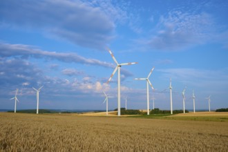 Several wind turbines on a field under blue sky and clouds, summer, Höhefeld, Wertheim,