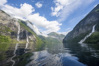 Atmospheric fjord landscape with waterfall The Seven Sisters and Freier Waterfall, Geirangerfjord