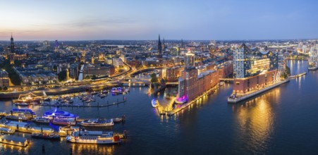 Panorama aerial view of the Elbphilharmonie at blue hour with illuminated windows and view over