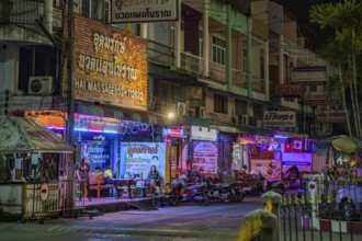 Massage parlor employees waiting for customers along a steet in Chiang Rai, Thailand, Asia