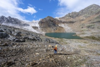 Mountaineer on a hiking trail, mountain landscape with limestone rocks between granite mountains,