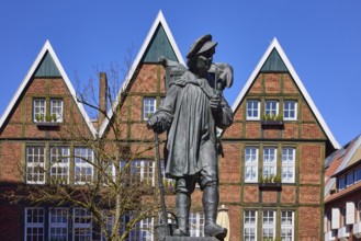 Kiepenkerl monument, bronze sculpture, brick architecture, facade, window, blue cloudless sky,